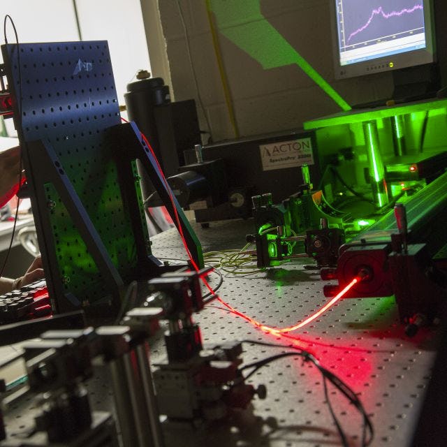 student in laser lab in the Department of Physics