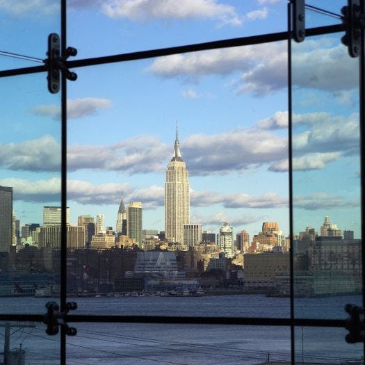 A view of lower Manhattan's skyline from Babbio's atrium. The shot is taken from inside the atrium, which consists of floor to ceiling windows.