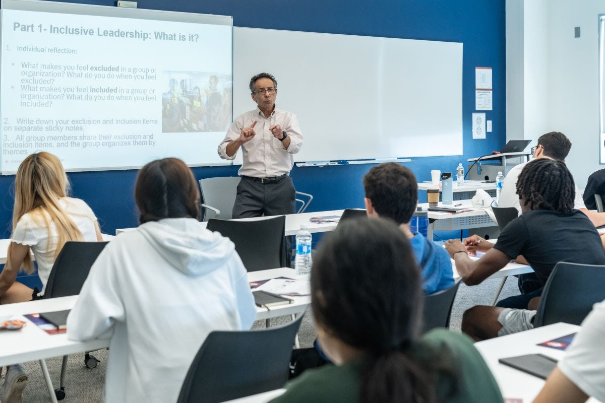 Professor Dominick speaking to a group of students