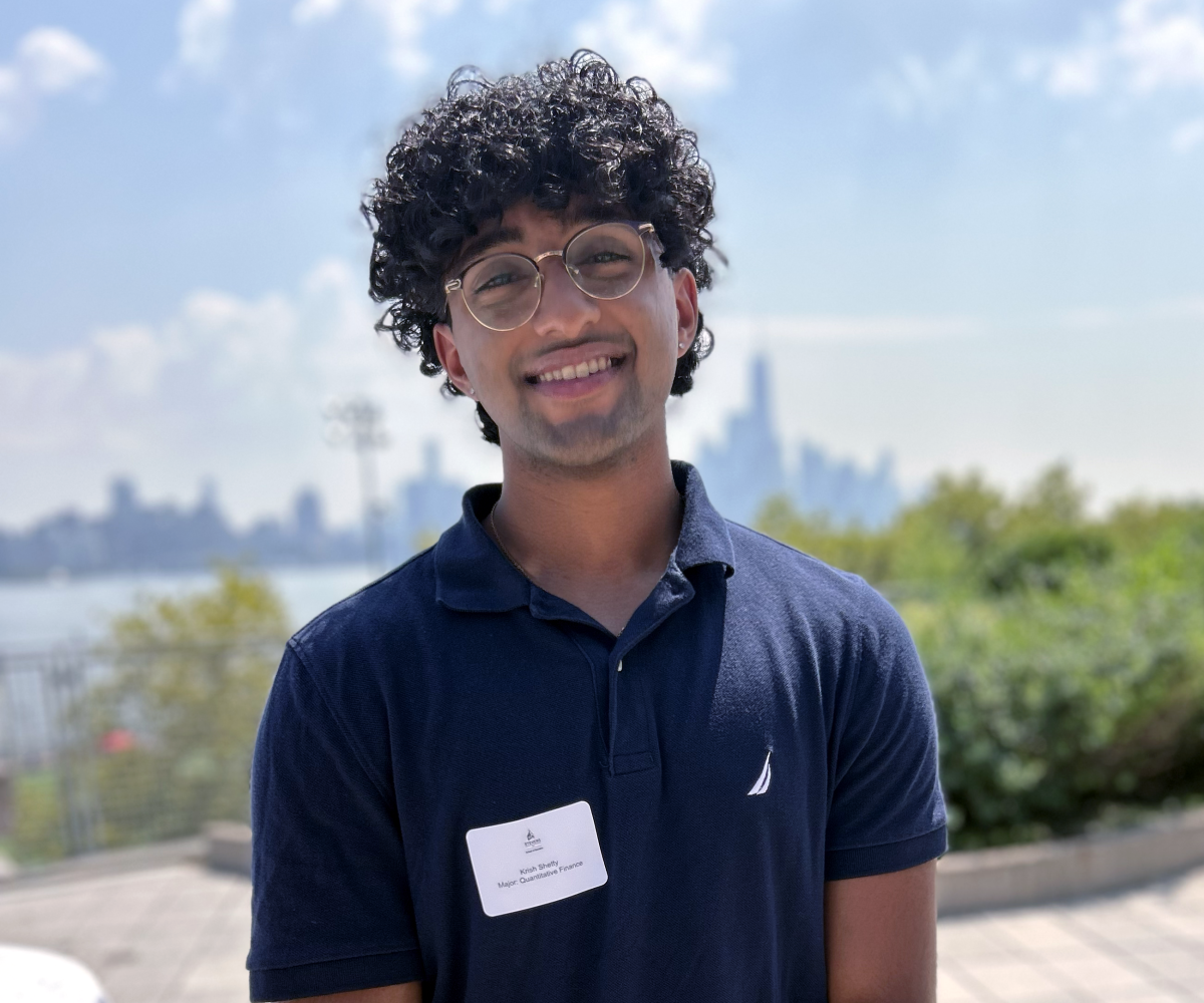 Krish Shetty stands on the Babbio Center patio. 