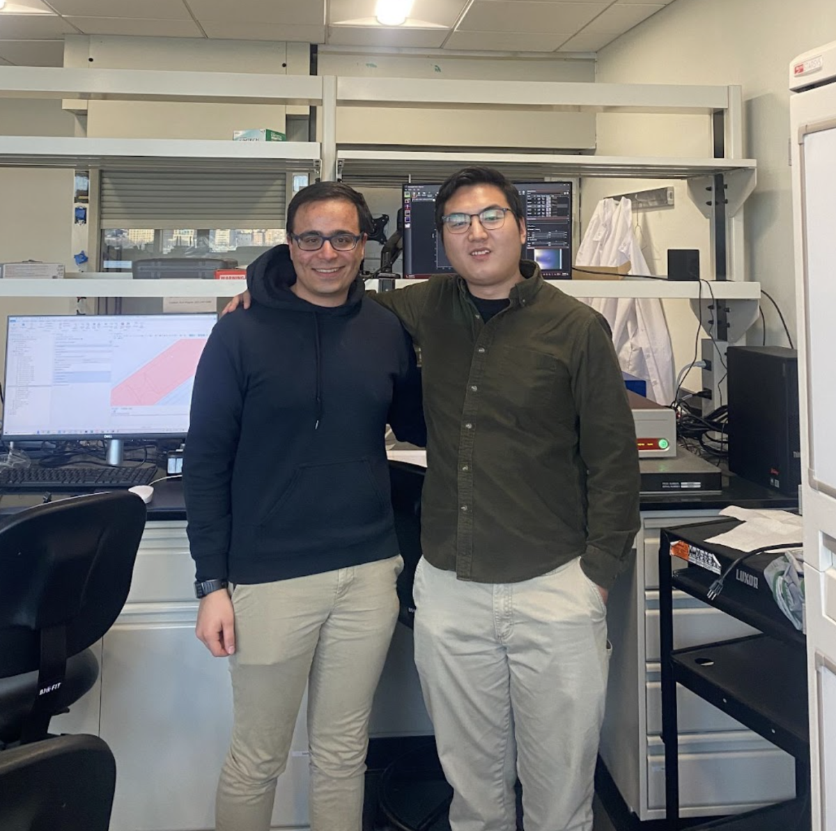Students Xueshen Li and Xueshen Li stand next to each other in a laboratory - the Intelligent Imaging and Image Processing Lab