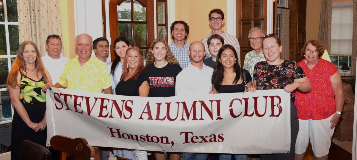 Alumni and students gather at a new student send-off event with a Stevens Alumni Club Houston Texas banner