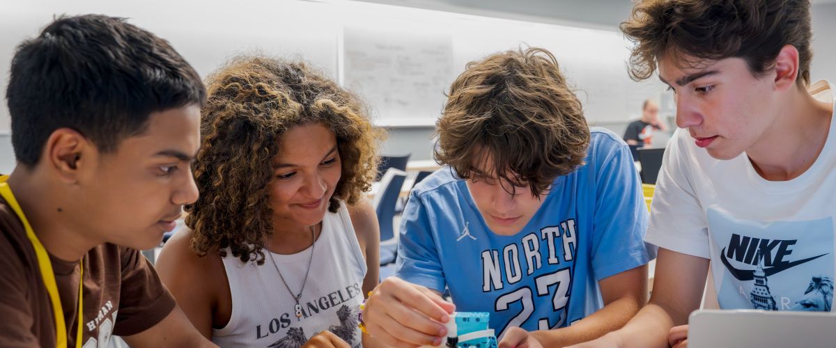 Group of 3 students working on an activity at a desk