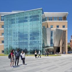 Plaza outside Babbio Center on a sunny day with students socializing.