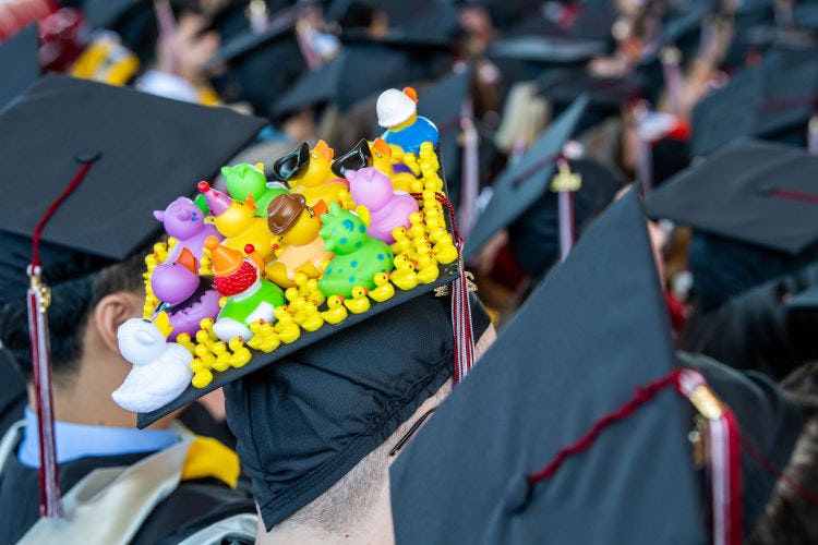 A commencement cap decorated with several rubber ducks.