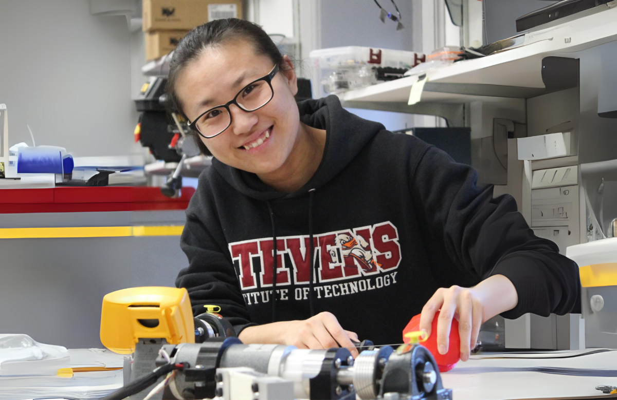 Qianwen Zhao, using her robot-assisted haptic joystick therapeutic device in the Wearable Robotic Systems Laboratory.