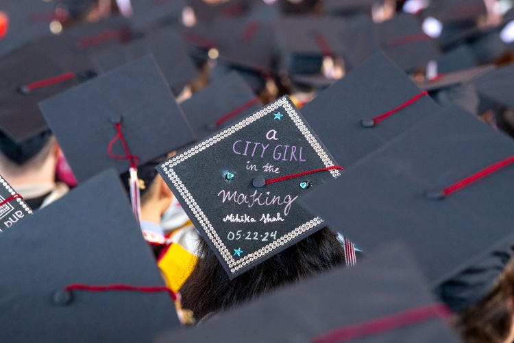 A graduation cap decorated with "A city girl in the making"