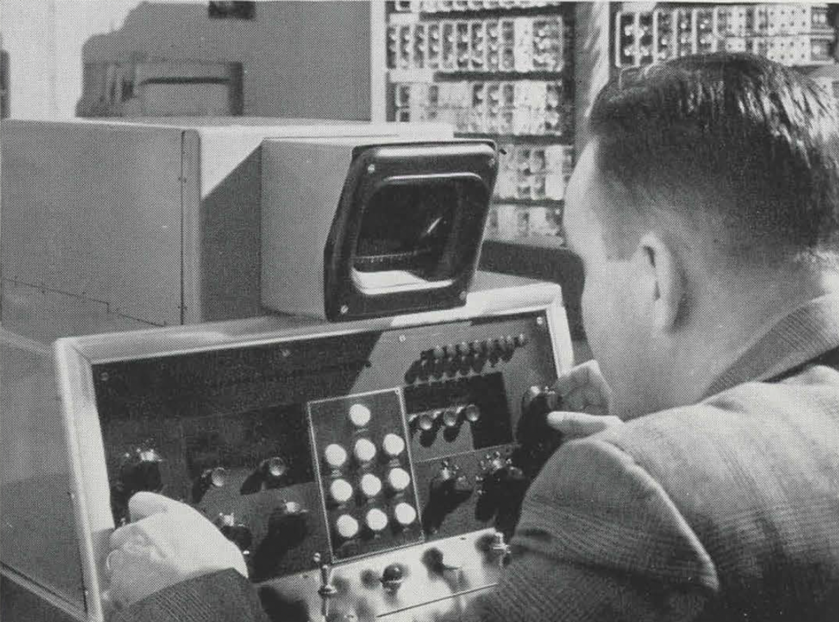 Black and white photo of student using a computer from the 1950's