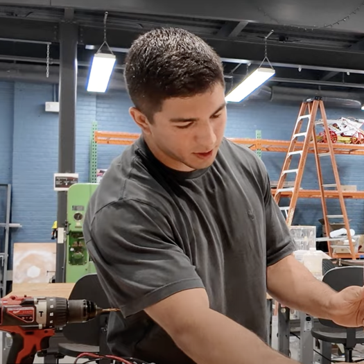 Student Harrison Hinojosa and Stevens Center for Sustainability Program Manager Rosita Nunez work on a water pressure project in the ABS Engineering Center.