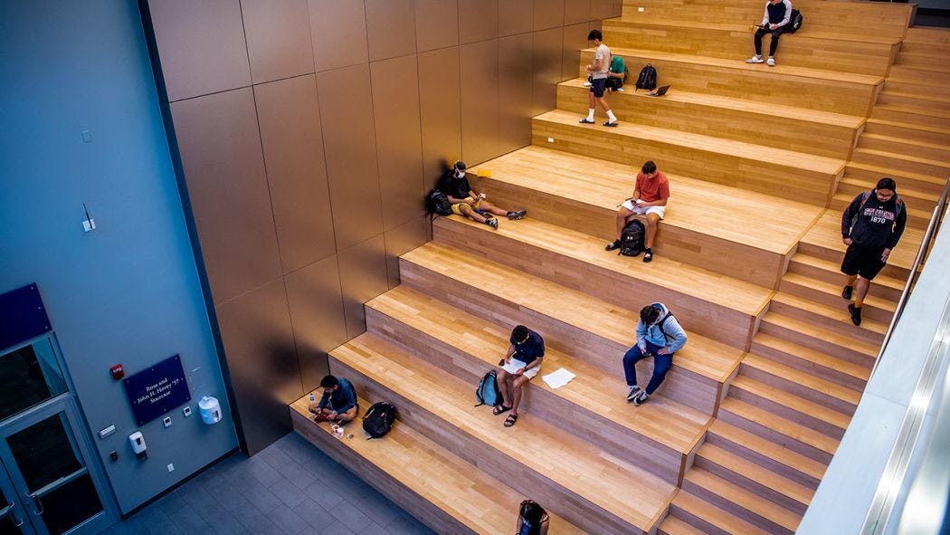 Students studying on staircase